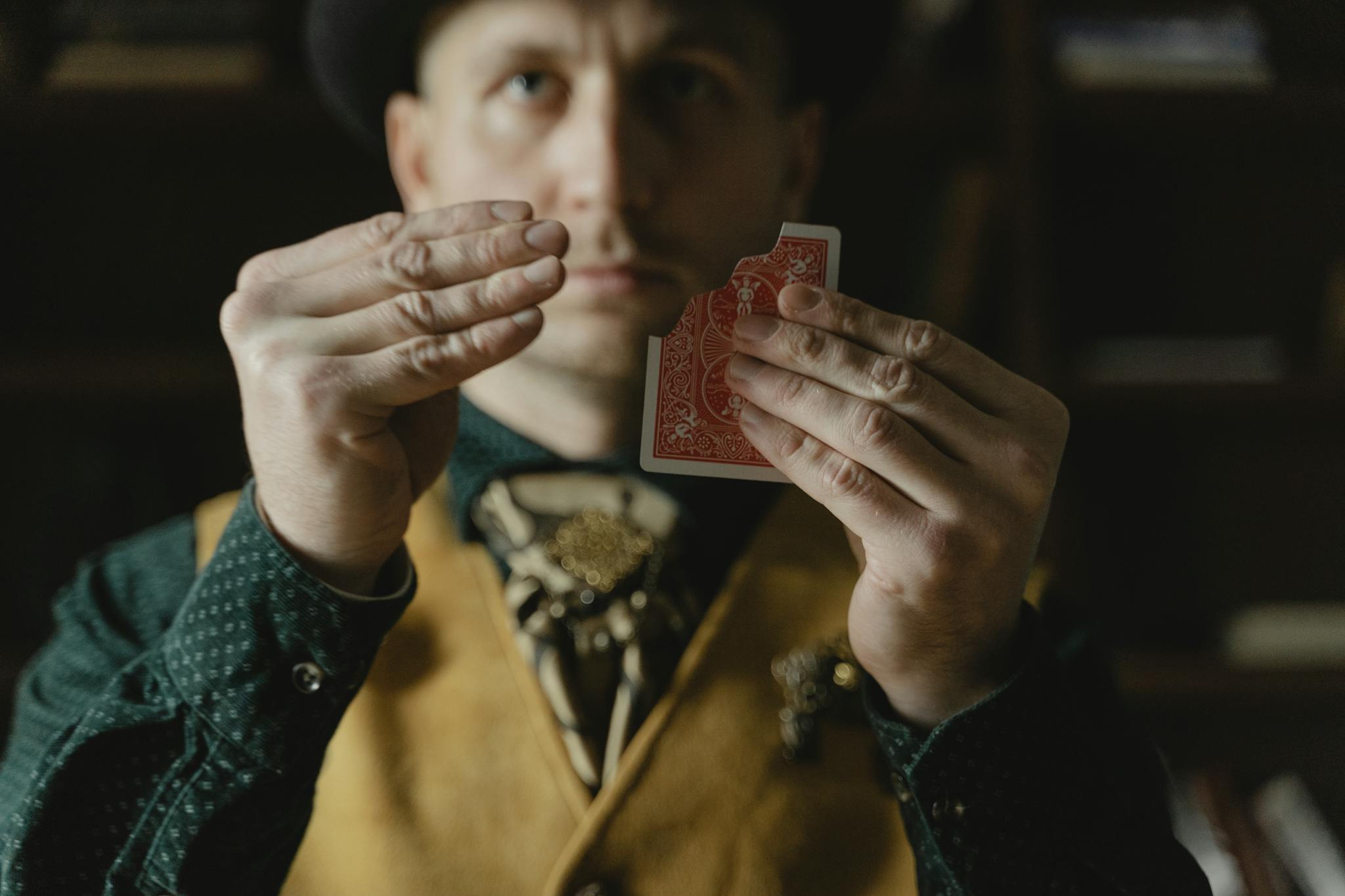 A magician skillfully performs a close-up card trick, adding mystery and intrigue.